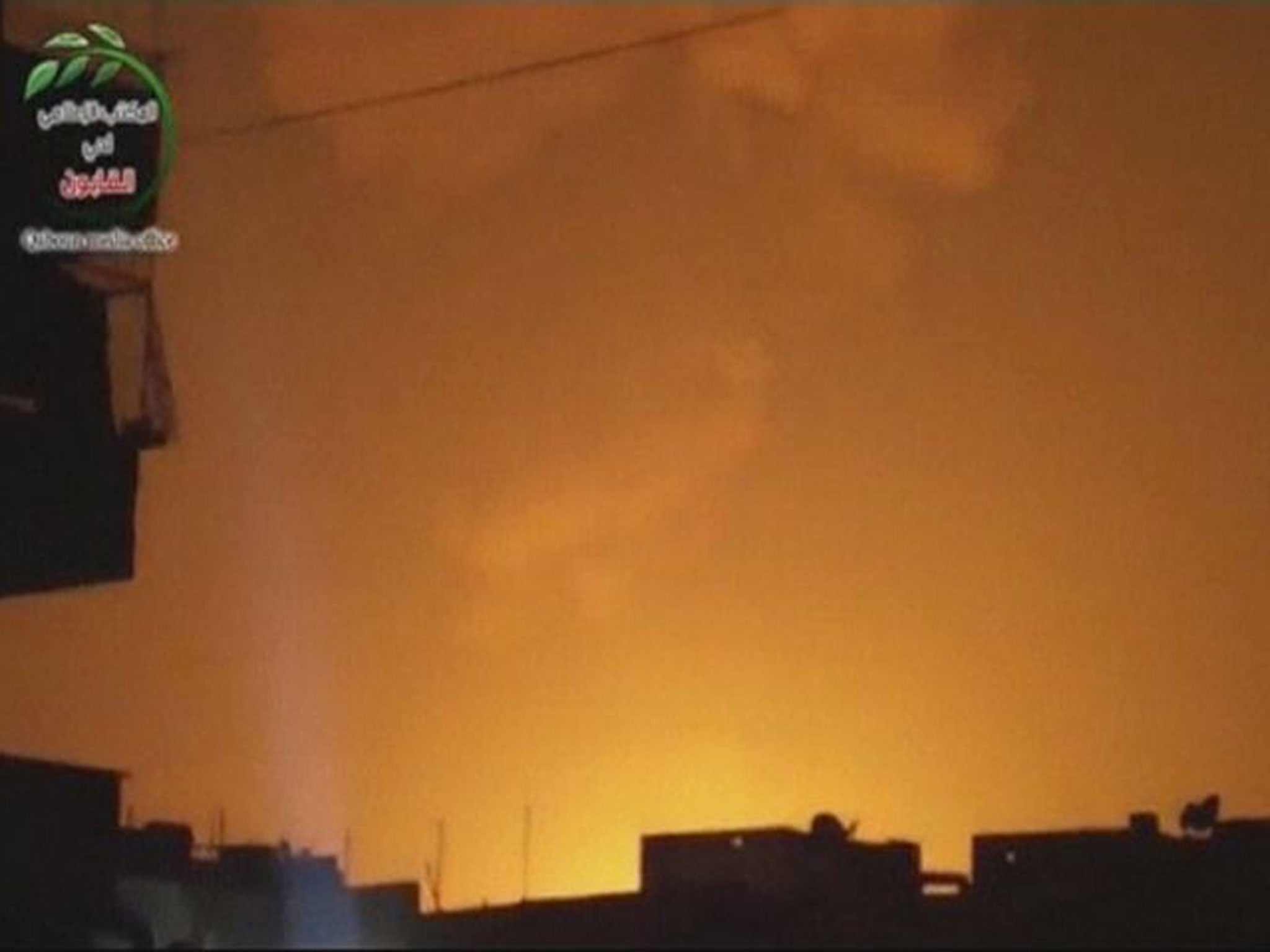 A still from an unverified video which claims to show sky lit up by an attack on a military research centre in Damascus