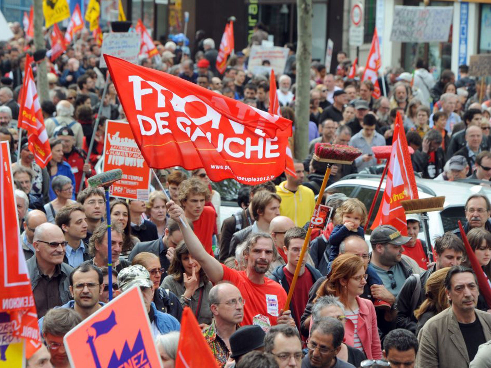 Tens of thousands of supporters of leftist parties marched through central Paris to express disappointment with President Francois Hollande’s first year in power