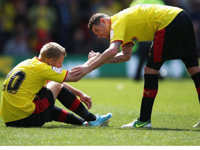 Mark Yeates gives his Watford team-mate Matej Vydra a hand up