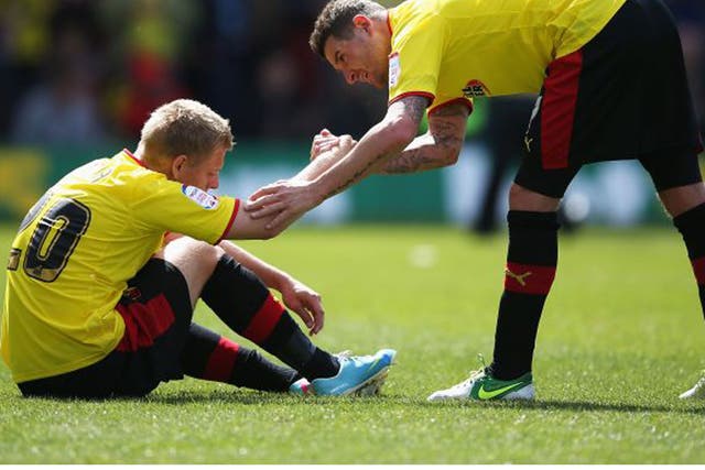 Mark Yeates gives his Watford team-mate Matej Vydra a hand up