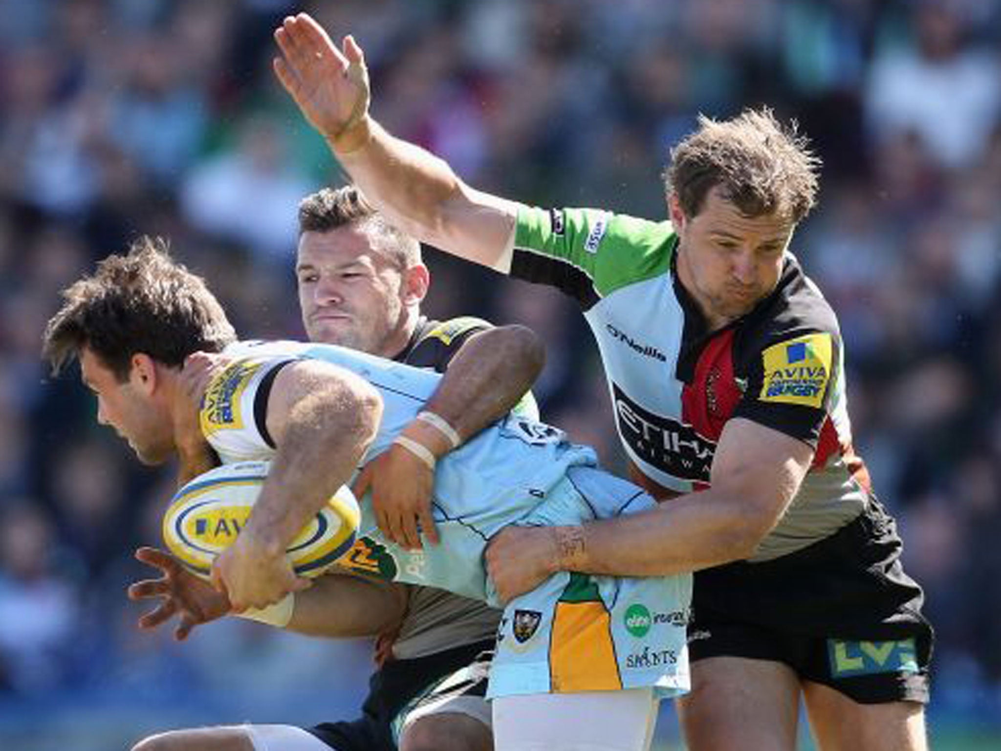 Harlequins’ Danny Care and Nick Evans get to grips with Northampton’s Ben Foden 