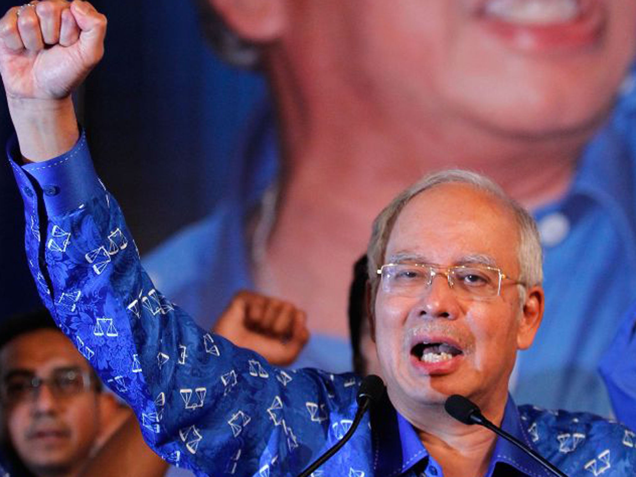 Prime Minister Najib Razak celebrates his victory as the ruling National Front won a majority in the national parliament
