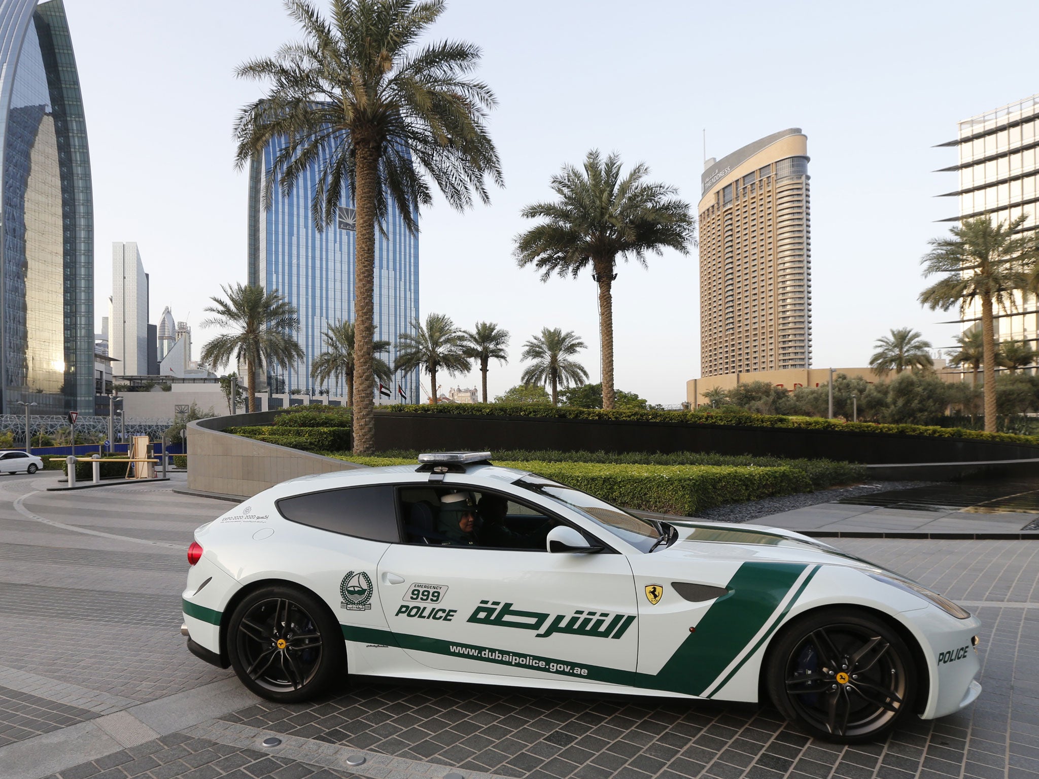 Emirati female police officers drive a Ferrari police vehicle in the Gulf emirate of Dubai on April 25, 2013. Dubai police showed off a new Ferrari they will use to patrol the city state, hot on the heels of a Lamborghini which joined the fleet earlier.