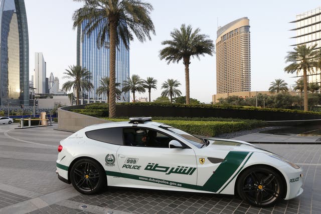 Emirati female police officers drive a Ferrari police vehicle in the Gulf emirate of Dubai on April 25, 2013. Dubai police showed off a new Ferrari they will use to patrol the city state, hot on the heels of a Lamborghini which joined the fleet earlier.