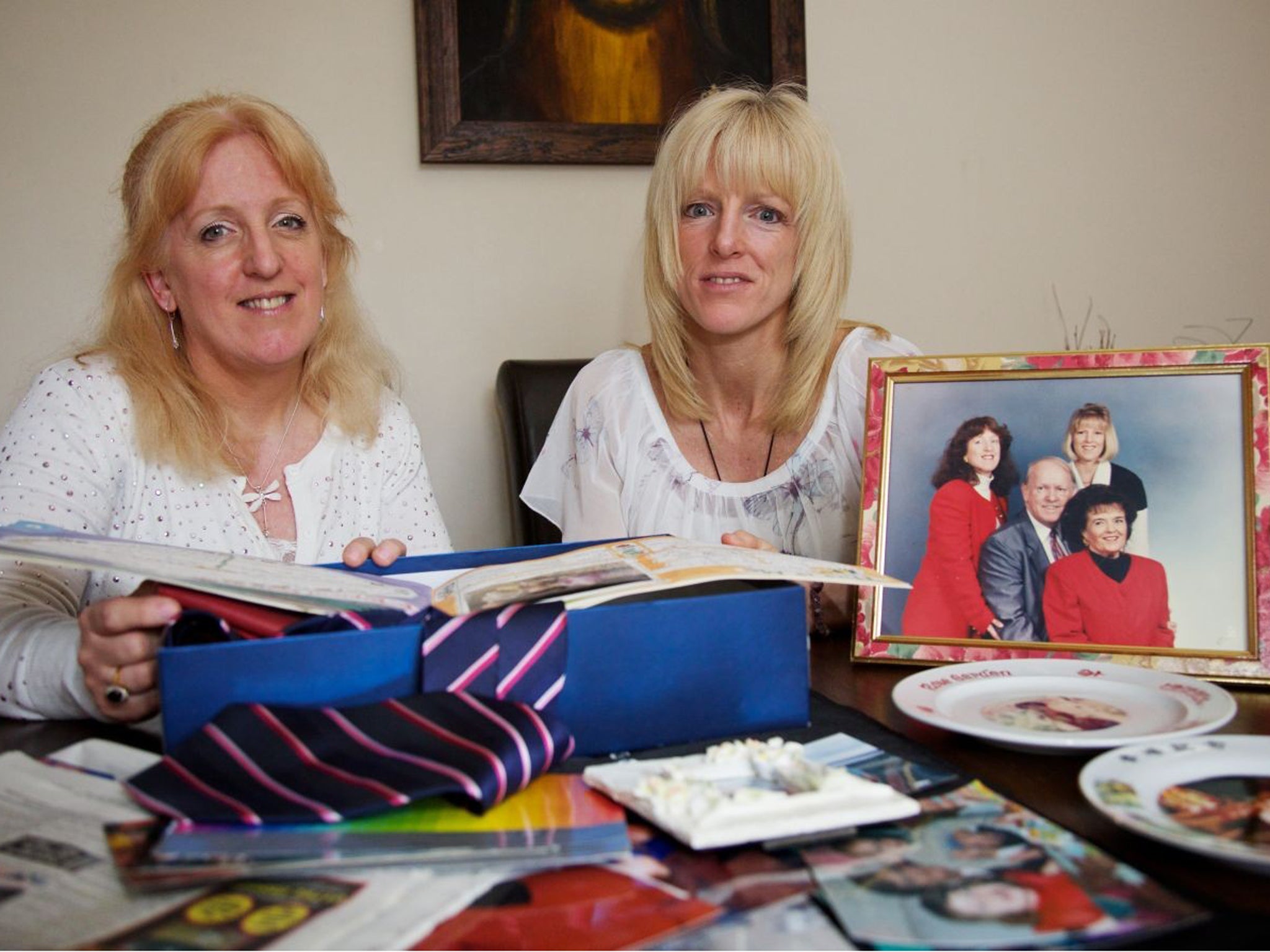 Nicky Locking, left, and Lisa Young, daughters of the Glovers, beside a picture of the family in 1994