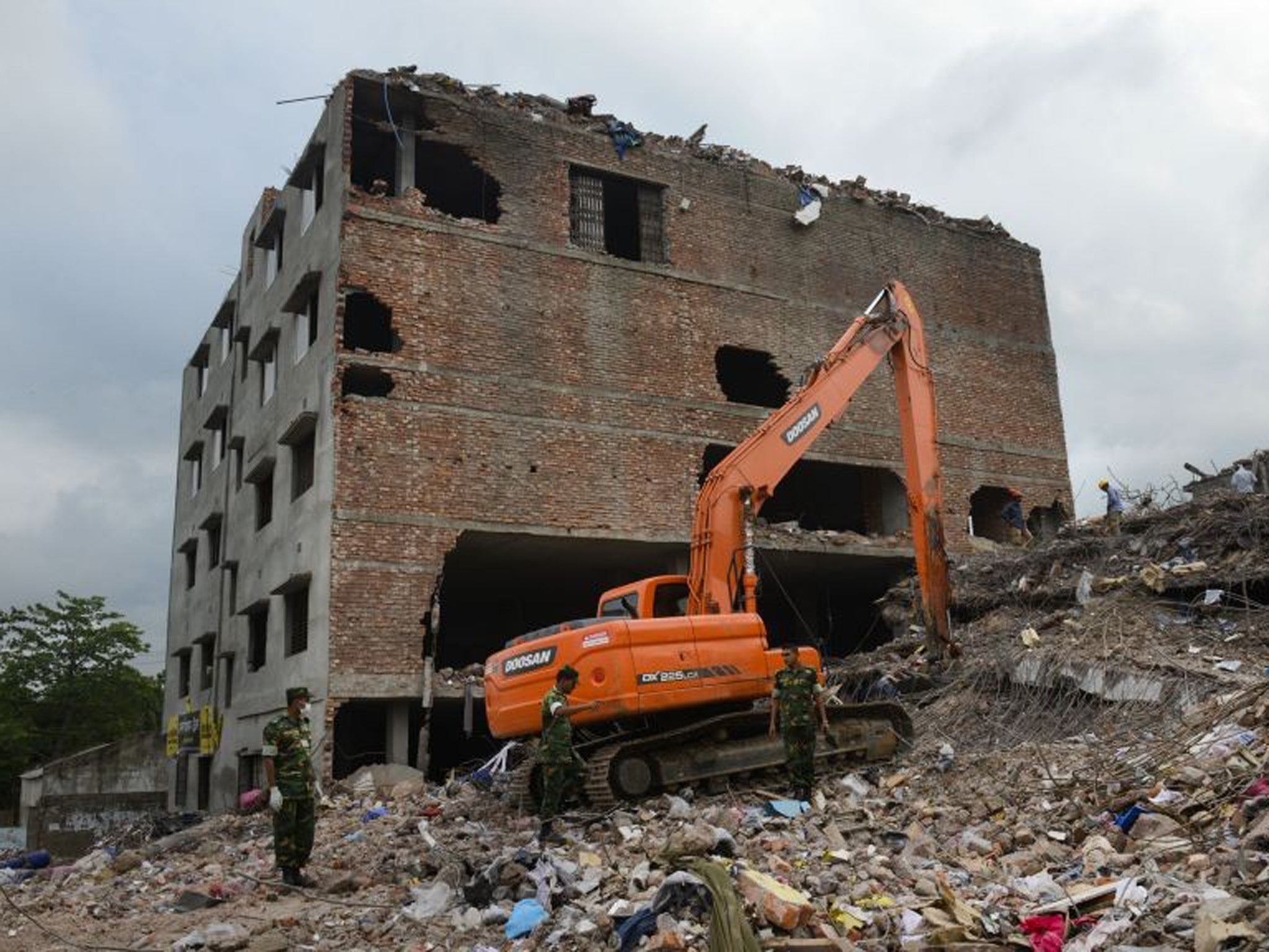 Workers and army personnel use heavy machinery to clear the site and recover bodies of victims from the rubble of the garment factory building collapse near Dhaka, Bangladesh