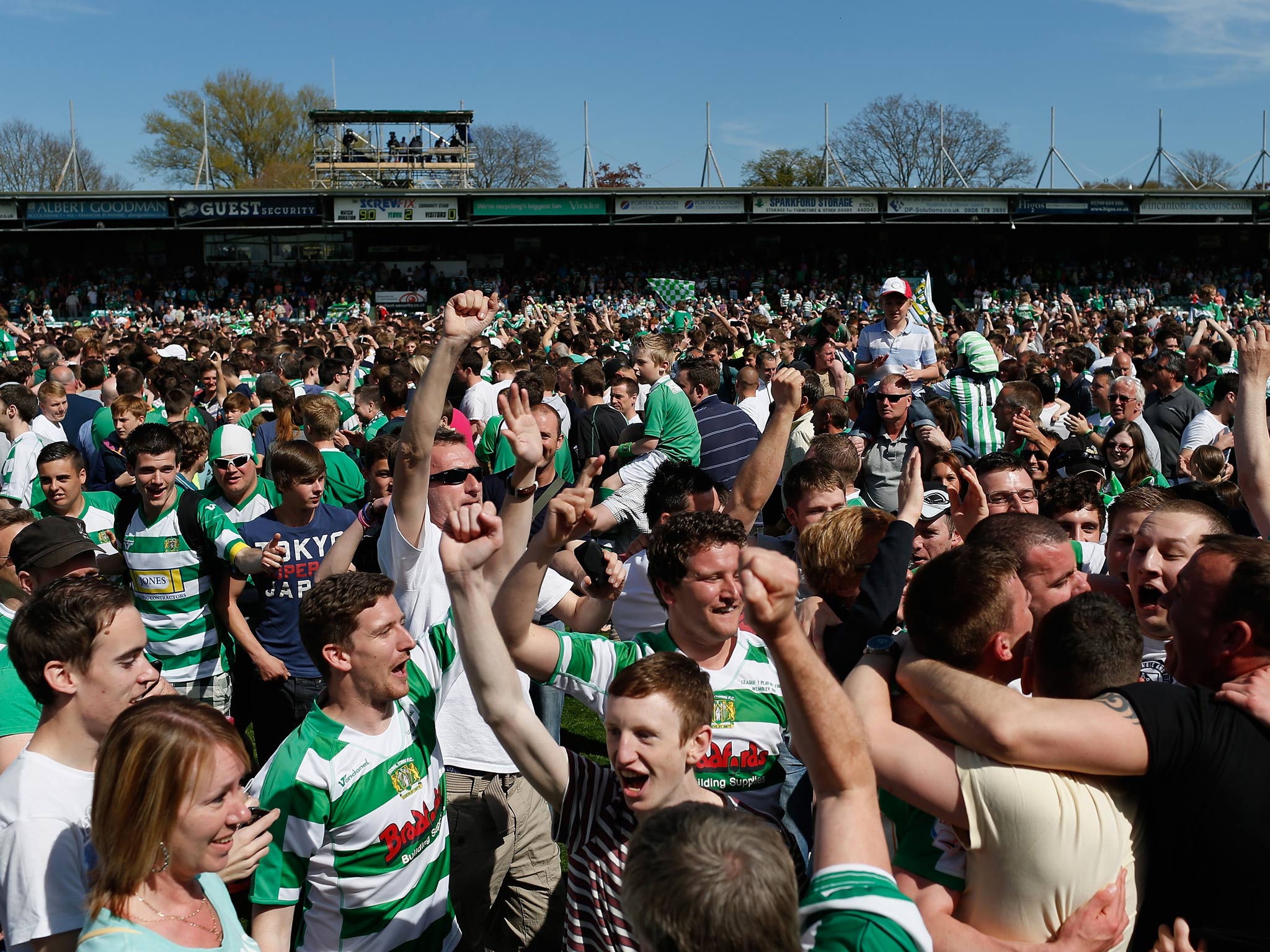 Yeovil fans flood the pitch at Huish Park after victory over Sheffield United to put them in the League One play-off final