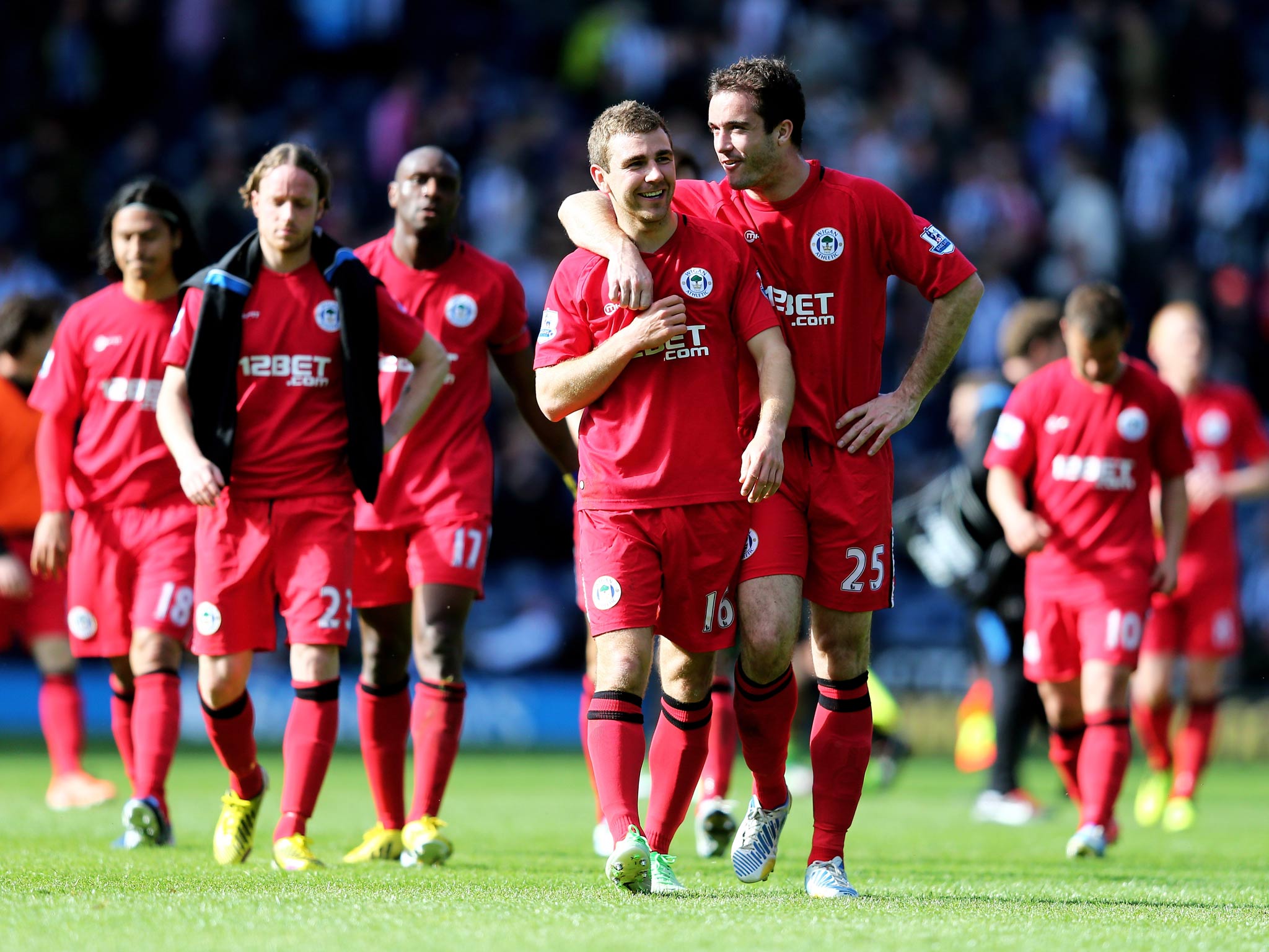 James McArthur and Roman Golobart of Wigan celebrate their team's 3-2 victory over West Brom