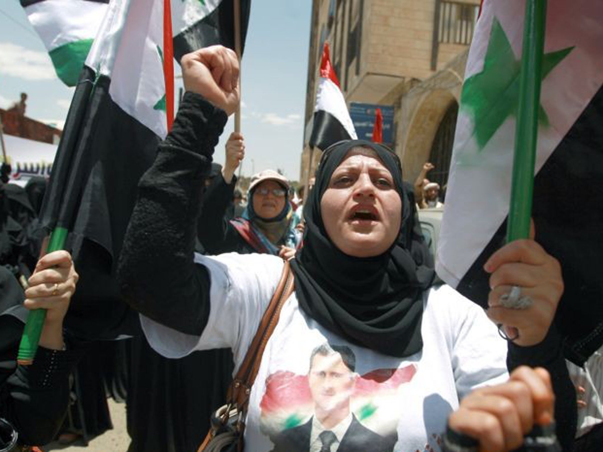 Pro-Syrian regime activists shout slogans during a march against the Israeli attacks on Syria as they rally outside the United Nations offices in the capital Sanaa