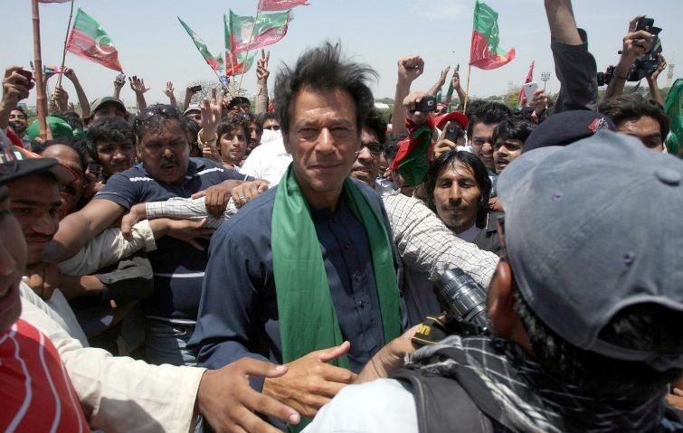 Before the fall in Lahore: the former test cricketer and now leader of the Pakistan opposition party Imran Khan is mobbed by supporters on his arrival for a rally ahead of general elections in Karachi