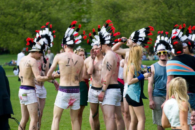 Cambridge students wearing Native American headdresses
