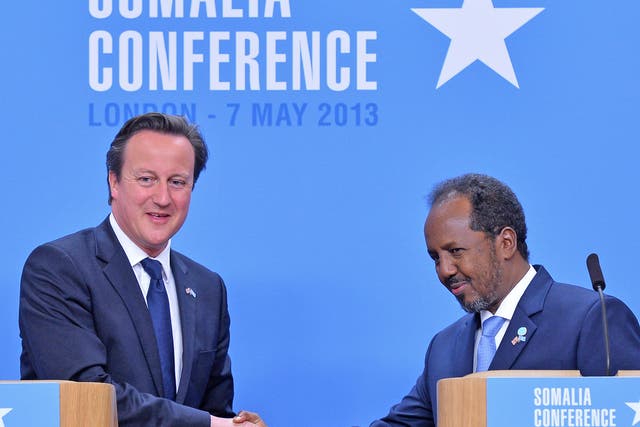 Prime Minister David Cameron shakes hands with Somali President Hassan Sheikh Mohamud