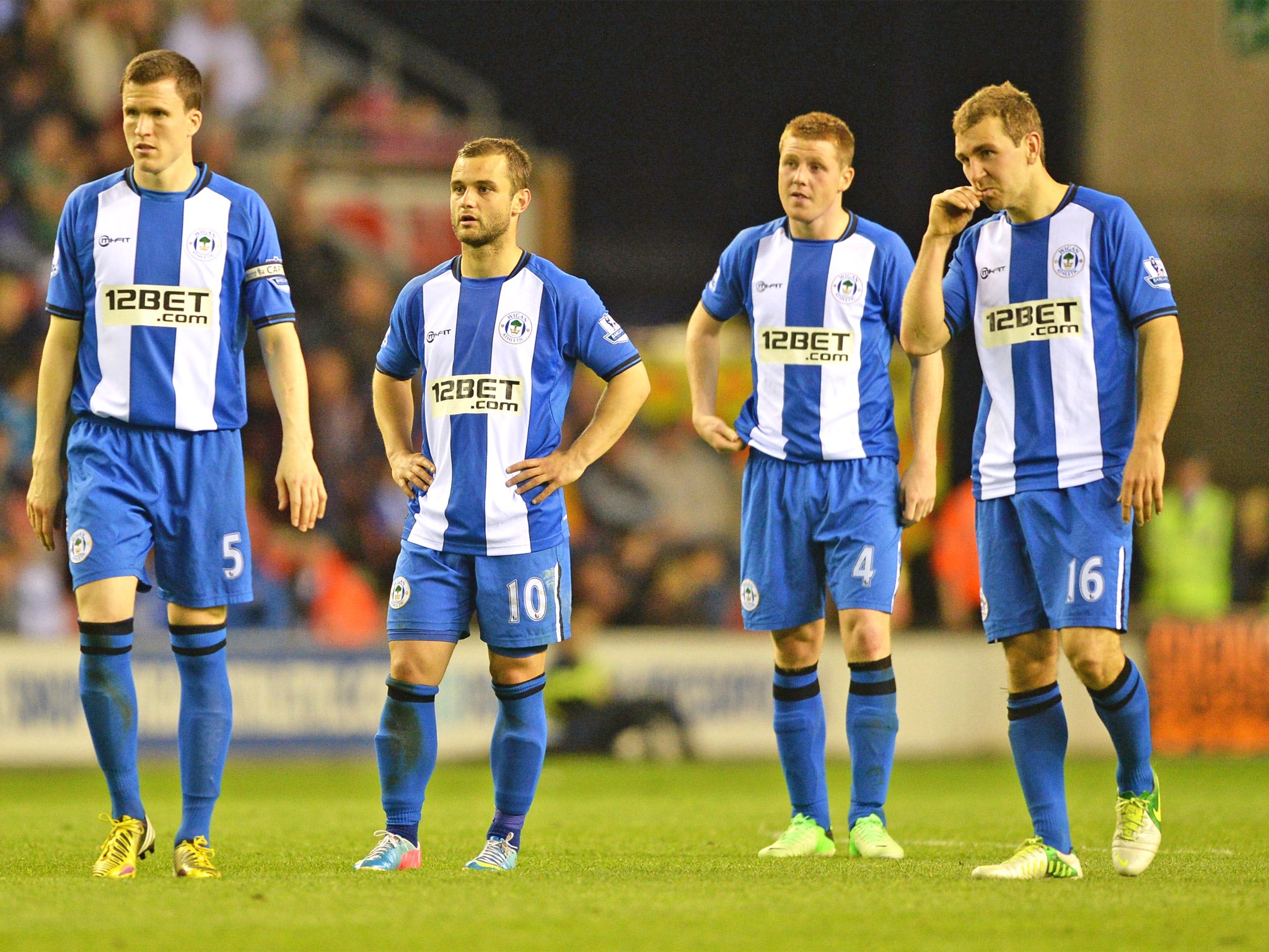 The Wigan players come to terms with what could prove to be a crucial defeat in their last Premier League game against Swansea