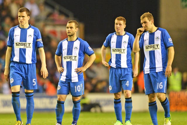The Wigan players come to terms with what could prove to be a crucial defeat in their last Premier League game against Swansea