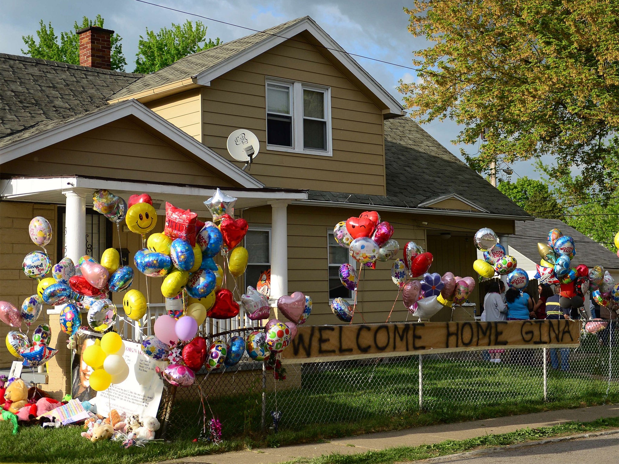 The family home of Gina DeJesus is decorated by well-wishers