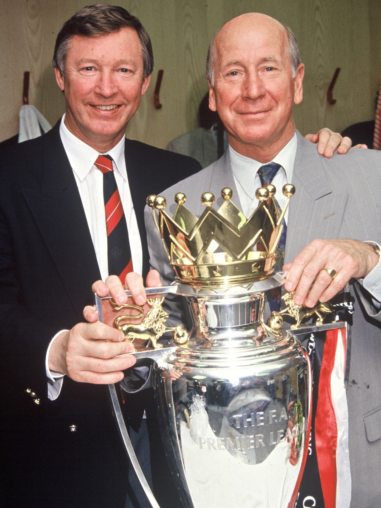 Charlton and Ferguson pose with the Premier League trophy after United were crowned champions in 1994
