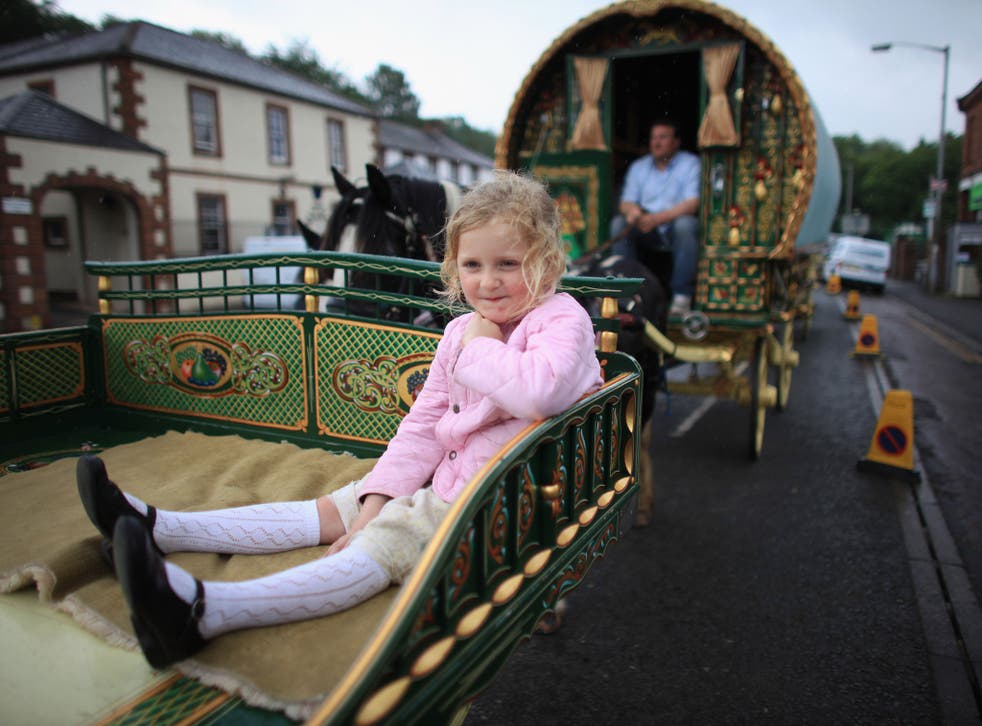 Traveller girl Mary Nicholson, aged six, arrives on her family's Romany Caravan at the Appleby Horse Fair on June 7, 2012 in Appleby, England. Appleby Horse Fair has existed under the protection of a charter granted by James II since 1685. It is one of the key gathering points for the Romany, gypsy and traveling community. Appleby Horse Fair is attended by about 5,000 travellers who come to buy and sell horses. The animals are washed and groomed before being ridden at high speed along the 'mad mile' for the viewing of potential buyers.