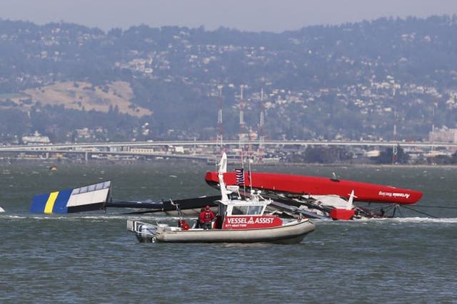 The Artemis Racing yacht is towed to shore after capsizing in the San Francisco Bay. British yacht-racing champion Andrew "Bart" Simpson, who won a gold medal at the 2008 Summer Olympics in Beijing, was killed when the vessel capsized during training for 