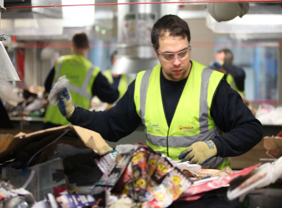 A worker sorts through the recycling at the £60m Veolia plant in Southwark, London