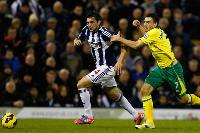 Goran Popov of West Bromwich Albion and Robert Snodgrass of Norwich City battle for the ball