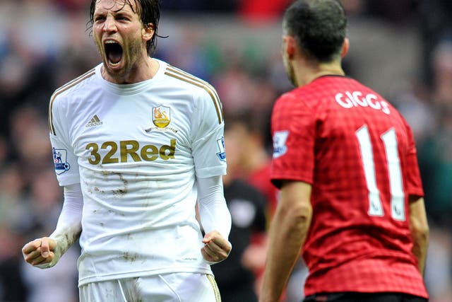 Swansea's Spanish player Michu (L) reacts after the final whistle during the English Premier League football match between Swansea City and Manchester United