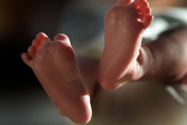 In this file photograph taken on March 20, 2007, a two-week-old boy finds his feet in his new world.