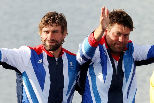Simpson, right, and Iain Percy step up to the Olympic podium at Weymouth last year  