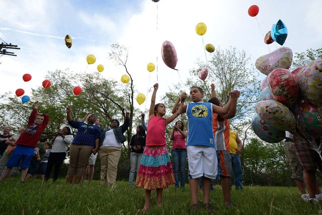 Children release balloons as part of a gathering outside a community meeting at Immanuel Lutheran Church held to talk about the kidnapping of Michelle Knight, Gina DeJesus and Amanda Berry by neighbour resident Ariel Castro