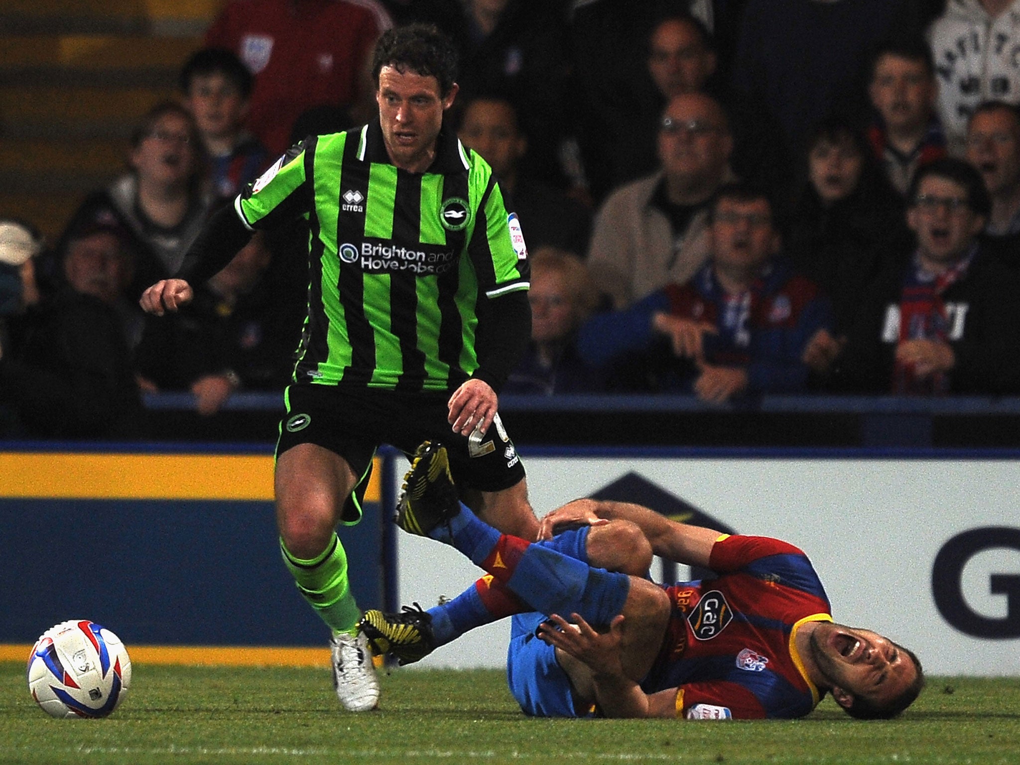 Glenn Murray of Palace goes down injured and is later taken off the field