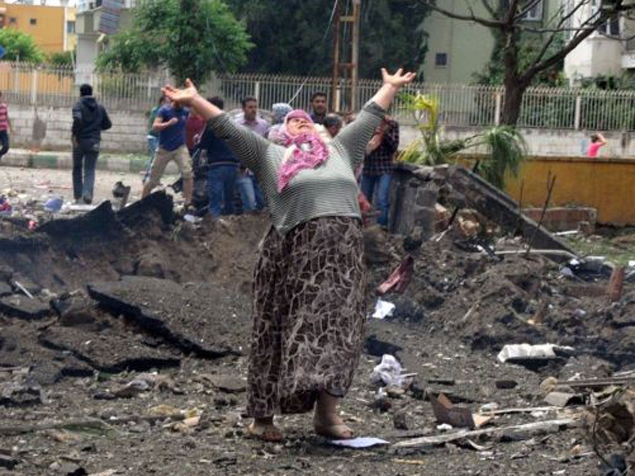 A woman reacts after the explosion in Rayhanli District, Hatay