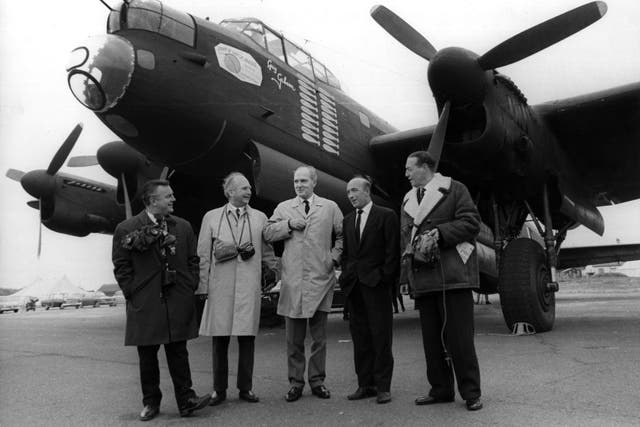 Dambuster crew members with a Lancaster bomber, pictured at a reunion in 1967