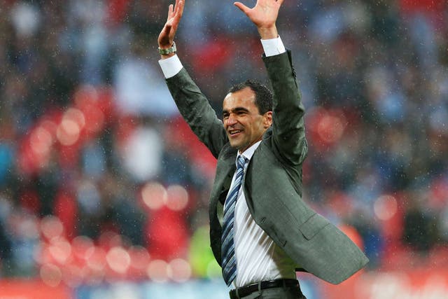 Roberto Martinez celebrates Wigan's famous FA Cup triumph in the pouring rain