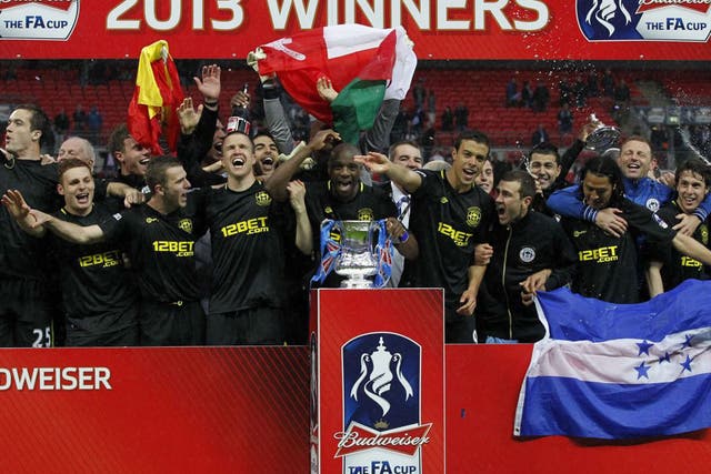 The Wigan team celebrate with the FA Cup (Ian Kingston/AFP/Getty Images)