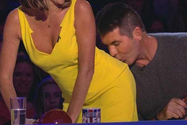 Simon Cowell (right) kissing Amanda Holden during filming of the ITV programme Britain's Got Talent
