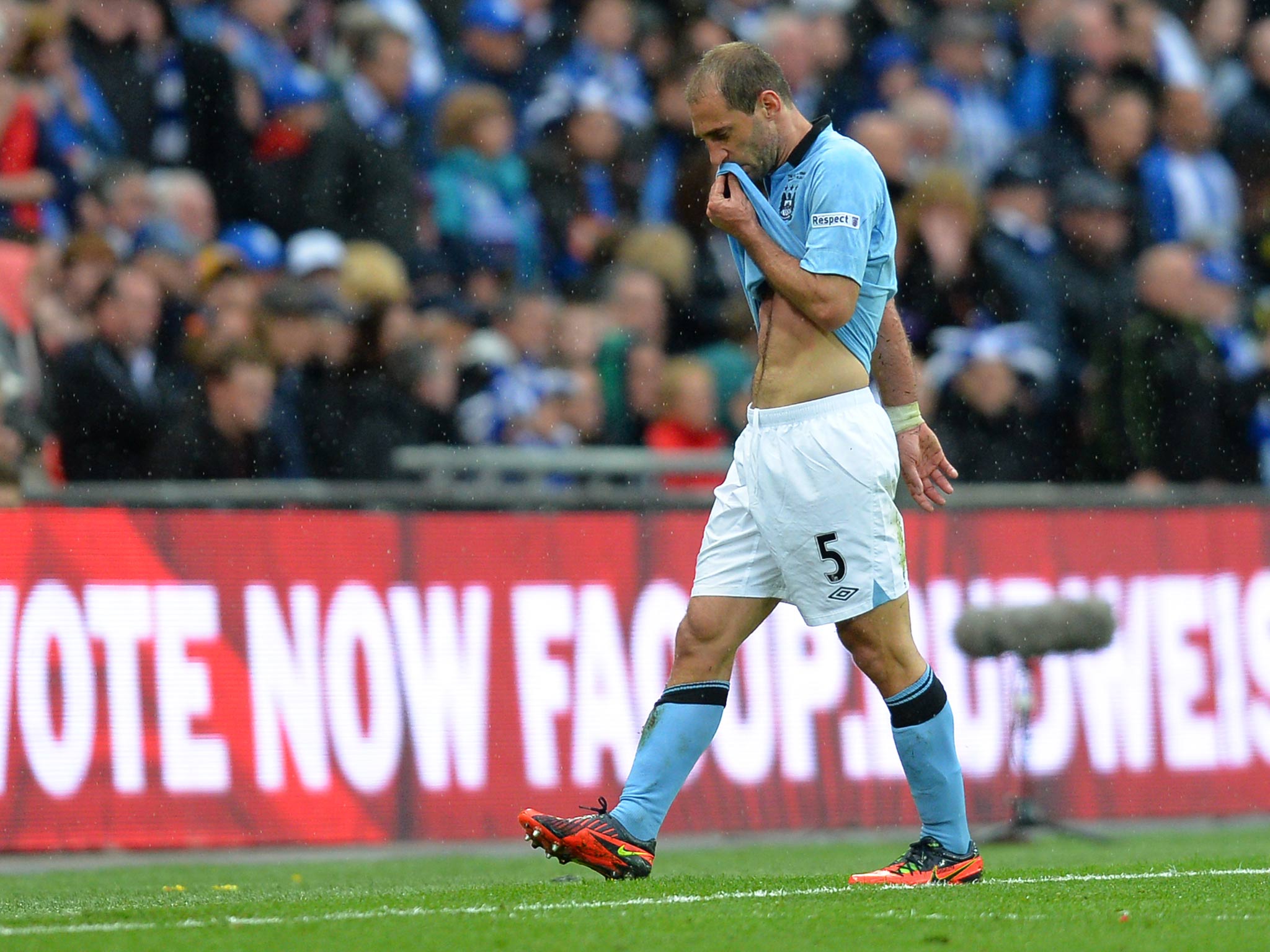 Pablo Zabaleta walks off the Wembley turf after being shown a red card for a second booking