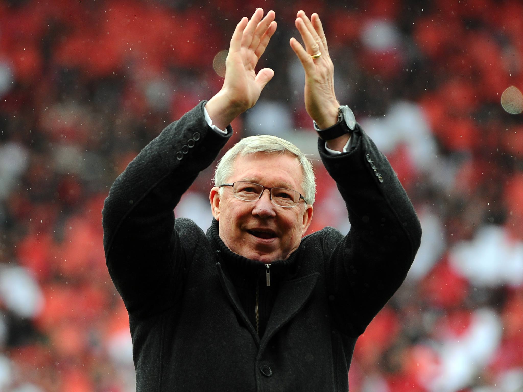 Sir Alex Ferguson applauds the Old Trafford crowd as he says goodbye before his retirement