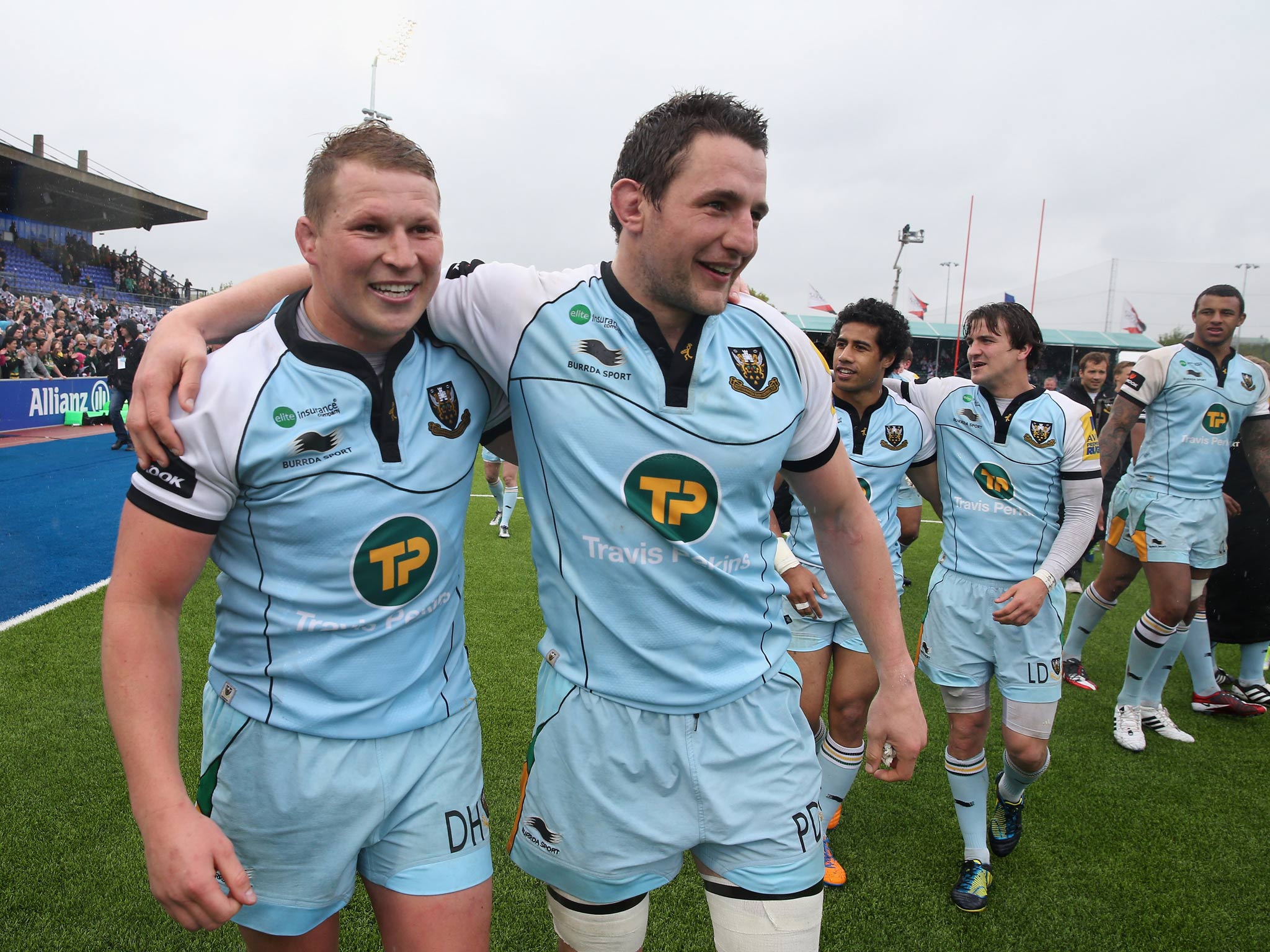 Northampton Saints captain Dylan Hartley celebrates with teammate Phil Dowson after their semi-final success