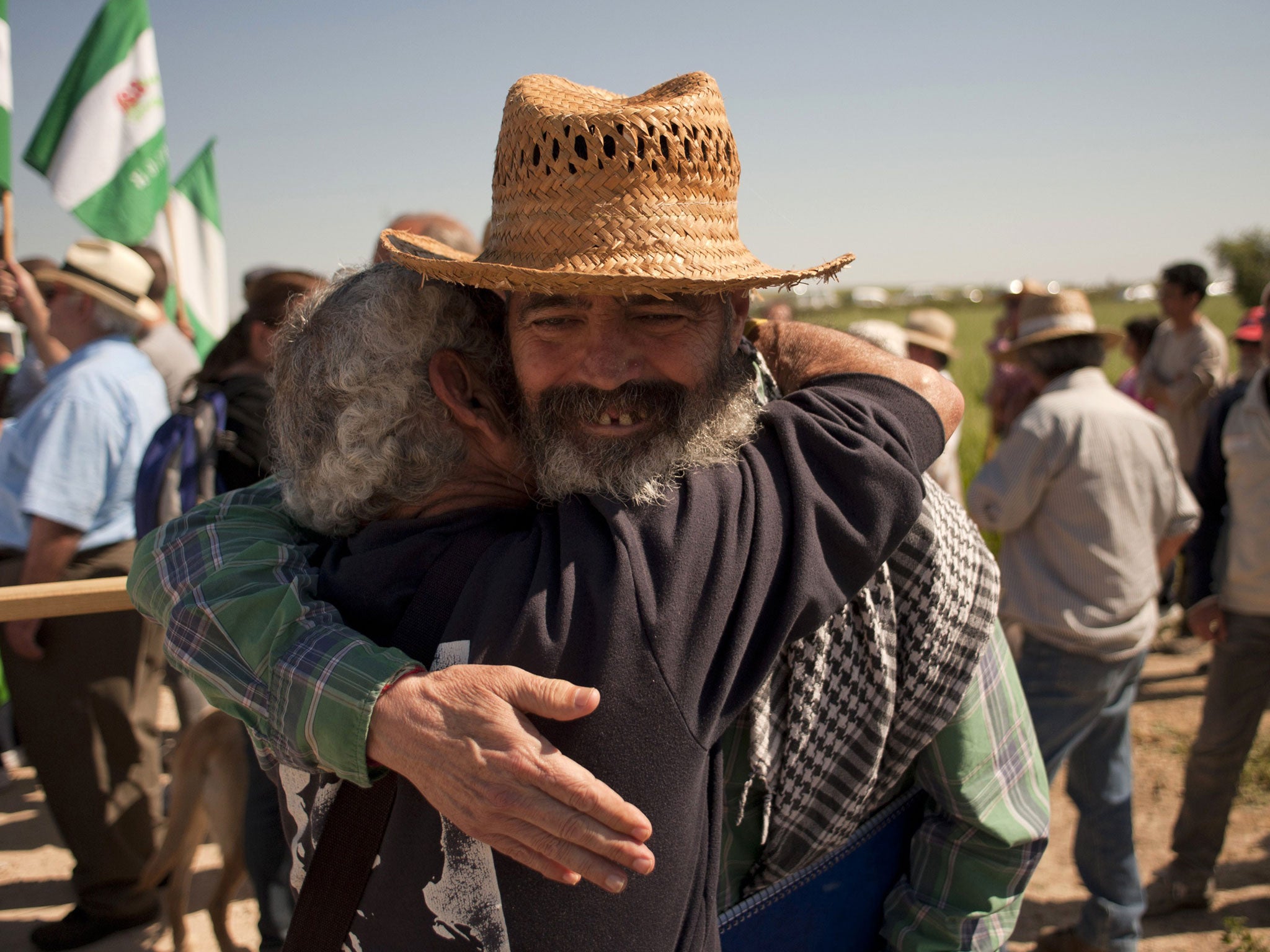 Juan Manuel Sánchez Gordillo embraces an activist during a land occupation this month