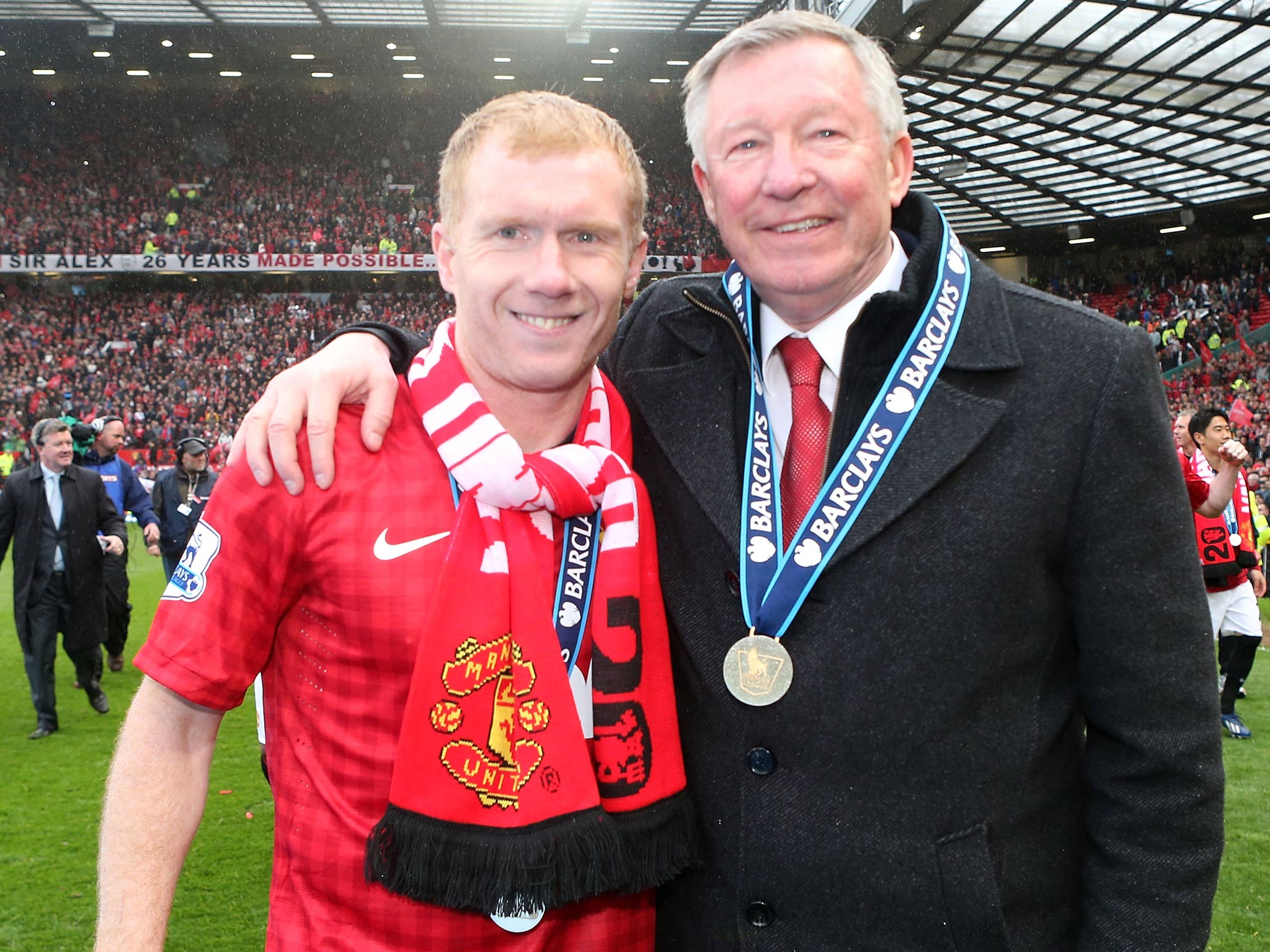 Paul Scholes celebrates with manager Sir Alex Ferguson as both prepare to retire from the game