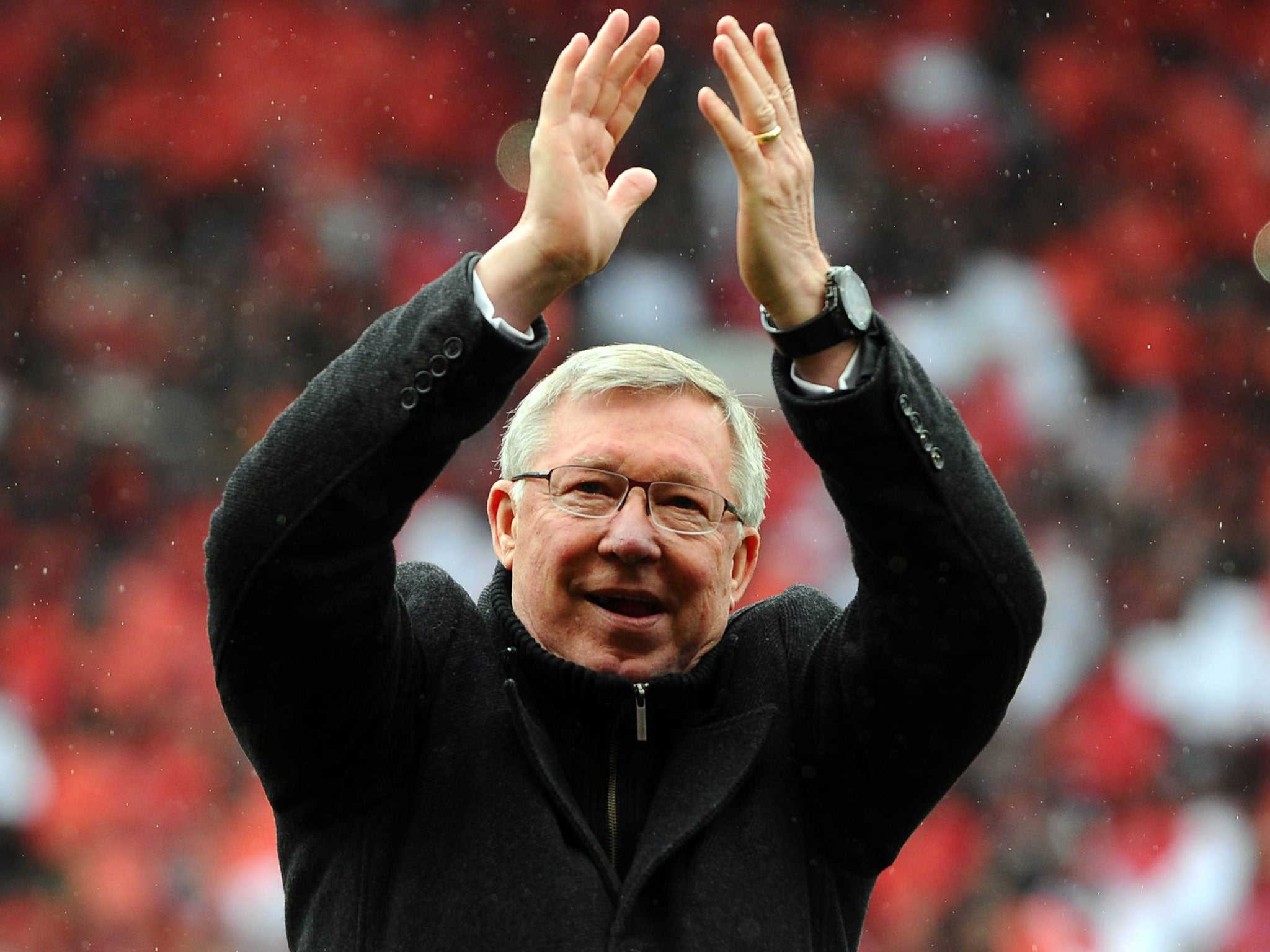 Manchester United's Scottish manager Alex Ferguson applauds as he arrives on the field (Andrew Yates/AFP/Getty Images)