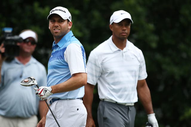 Sergio Garcia, left, and Tiger Woods, right, had another frosty round