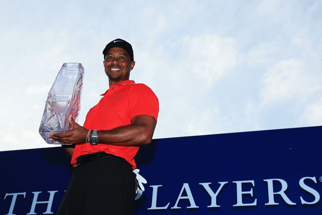 Tiger Woods holds the winner's trophy after the final round of The Players Championship (Richard Heathcote/Getty Images)