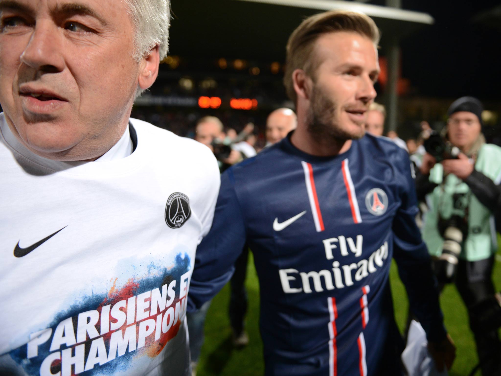 Italian coach Carlo Ancelotti and midfielder David Beckham celebrate PSG's Ligue 1 win