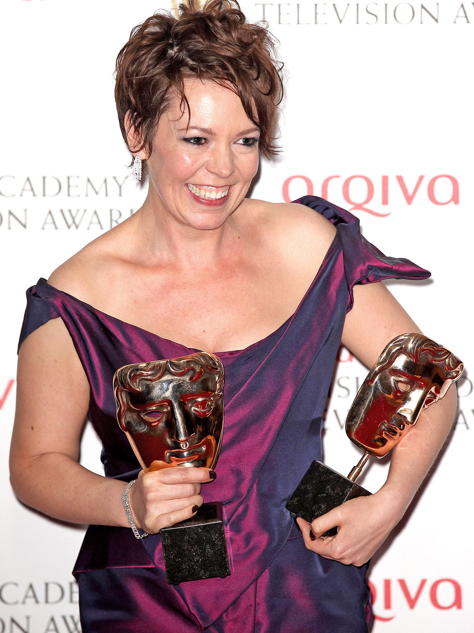 Olivia Coleman poses with her BAFTA awards