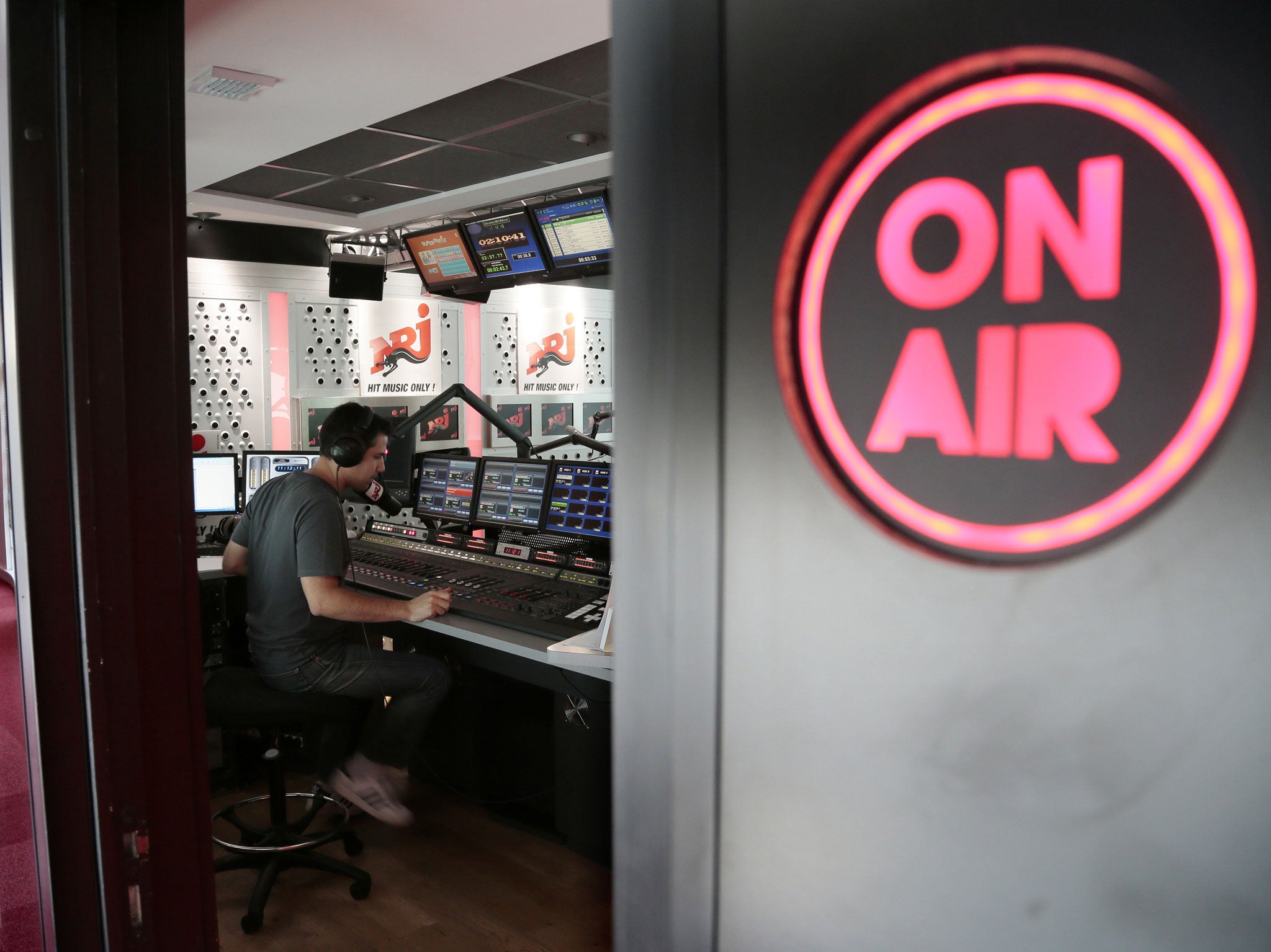 A technician is at work, on July 24, 2012 in Paris, in a studio of the French multimedia NRJ (acronym read as energie in French) group.