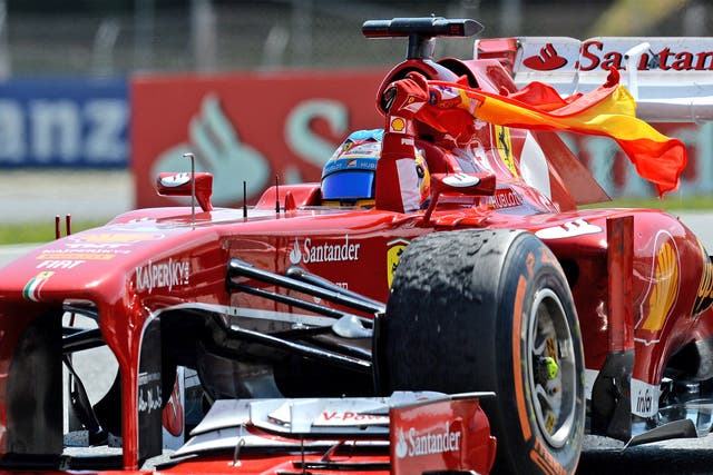 Fernando Alonso after winning the Spanish Grand Prix on Sunday, with a battered front tyre clearly visible