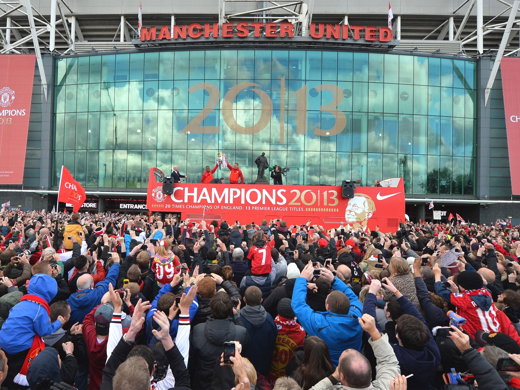 Patrice Evra and Nemanja Vidic lift the trophy outside Old Trafford