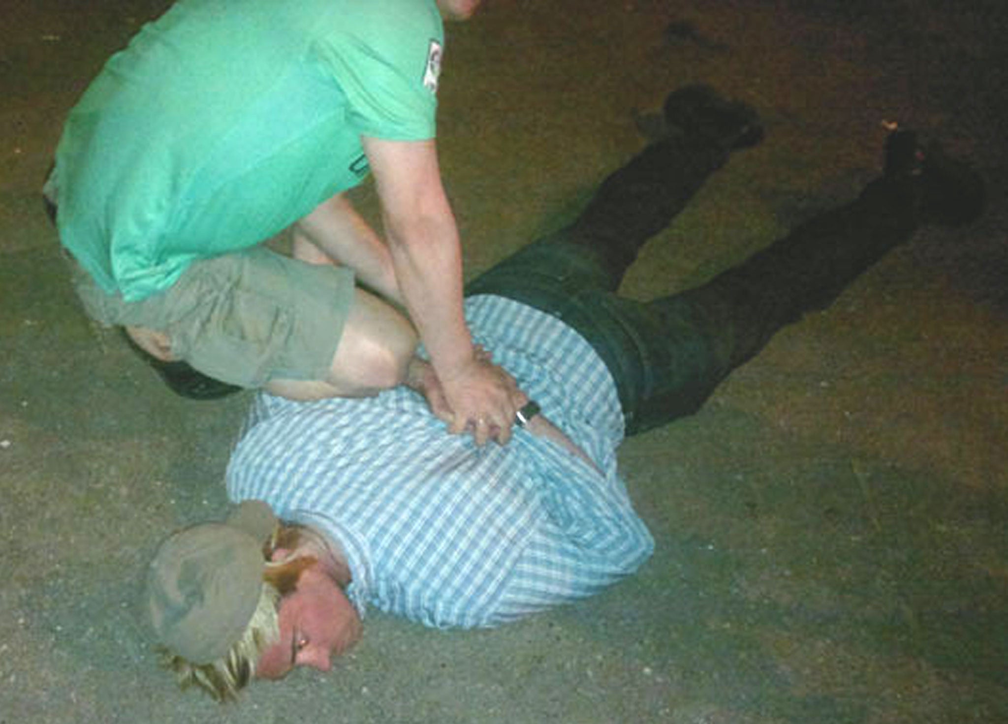 Pictures released showing Ryan Fogle, in a blond wig and cap, being wrestled to the ground by Russian agents