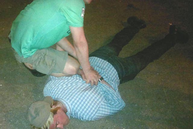 Pictures released showing Ryan Fogle, in a blond wig and cap, being wrestled to the ground by Russian agents