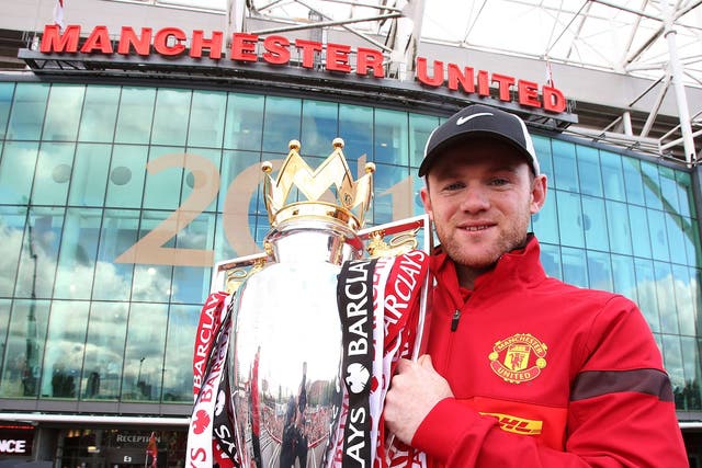 Wayne Rooney celebrates with the Premier League trophy